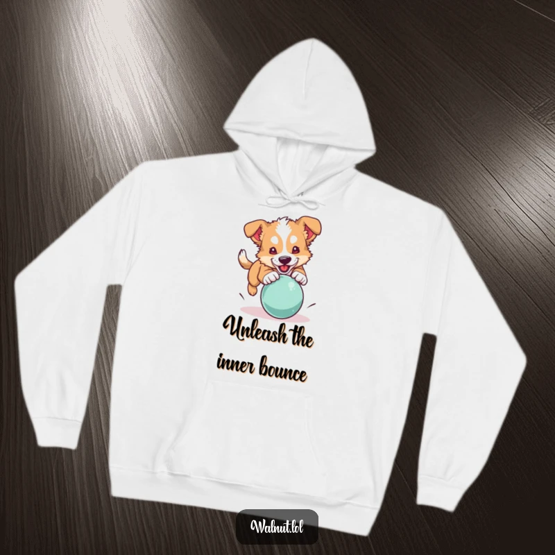 Funny dog hoodie showing a wild dog energetically pouncing on a bouncing ball, perfect for chilly days.